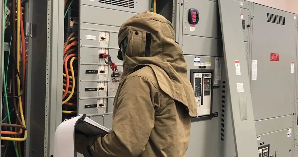 worker in PPE performing arc flash assessment