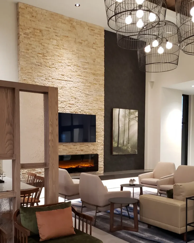 apartment common area with electric fireplace and overhead lighting